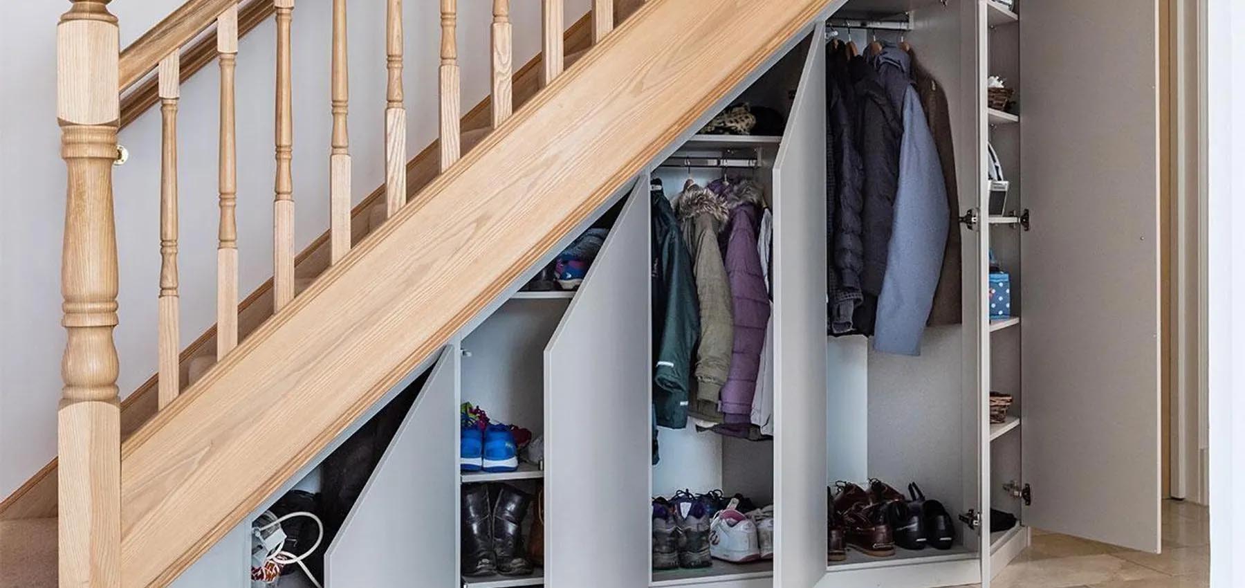Understairs storage with pull-out drawers and hidden compartments in London